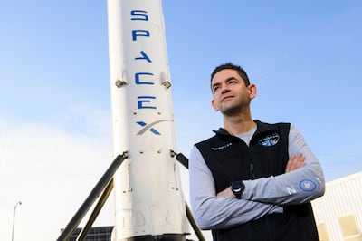 Inspiration4 mission commander Jared Isaacman, founder and chief executive officer of Shift4 Payments, in front of a Falcon 9 rocket. AFP