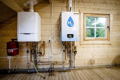 An old central heating boiler (L) and a hydrogen boiler inside the Hydrogen Experience Centre in Apeldoorn on May 27, 2021, the hydrogen house of certification body Kiwa and energy company Alliander. The house serves as a training location for technicians, who can learn how residences can be powered by hydrogen.  - Netherlands OUT
 / AFP / ANP / Sem van der Wal
