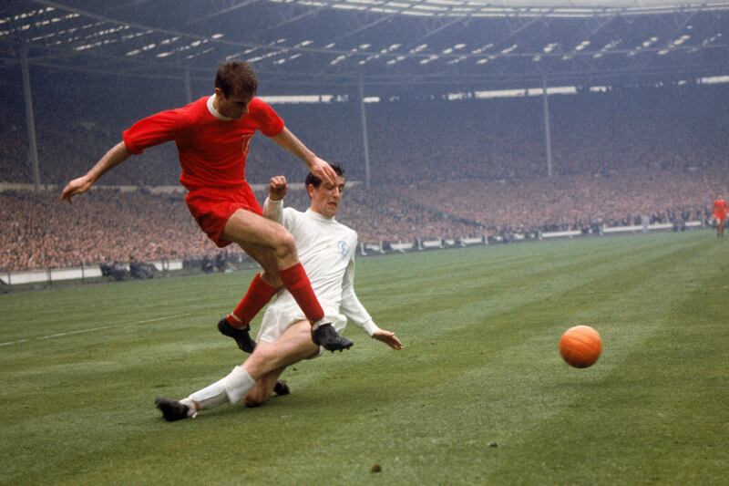 Leeds United's Norman Hunter (r) slides in too late to prevent Liverpool's Roger Hunt (l) firing the ball across. Alamy