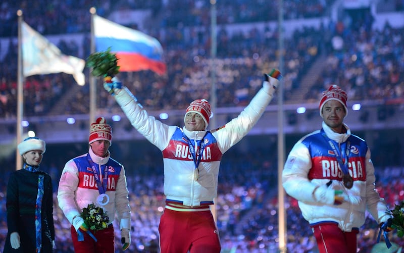 (FILES) This file photo taken on February 23, 2014 shows Russia's silver medalist Maxim Vyleghzanin (L), Russia's gold medalist Alexander Legkov (C) and Russia's bronze medalist Ilia Chernousov after the Men's Cross-Country Skiing 50km Mass Start Free Victory Ceremony at the Closing Ceremony of the Sochi Winter Olympics. Alexander Legkov became the first athlete stripped of an Olympic medal from the 2014 Sochi games. 
A congress of national Olympic committees on November 3, 2017 slammed calls for a blanket ban on Russian athletes for the 2018 Winter Olympics in South Korea, warning against politics interfering with sports. / AFP PHOTO / KIRILL KUDRYAVTSEV