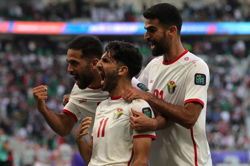 Jordan's Yazan Al Naimat celebrates with teammates after scoring his team's second goal in their Asian Cup match against South Korea at the Al Thumama Stadium. AFP