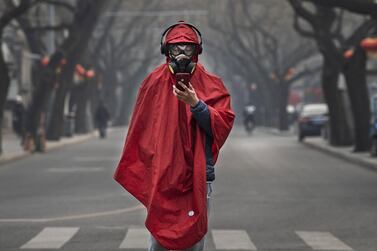 A man wears a protective mask, goggles and coat as he stands in a nearly empty street during the Chinese New Year holiday in Beijing. China has restricted the movements of over 50 million people to contain the virus. Getty Images
