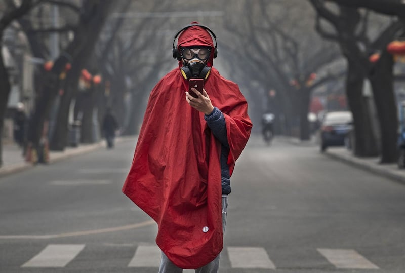 BEIJING, CHINA - JANUARY 26: A Chinese man wears a protective mask, goggles and coat as he stands in a nearly empty street during the Chinese New Year holiday on January 26, 2020 in Beijing, China. The number of cases of a deadly new coronavirus rose to over 2000 in mainland China Sunday as health officials locked down the city of Wuhan earlier in the week in an effort to contain the spread of the pneumonia-like disease. Medical experts have confirmed the virus can be passed from human to human. In an unprecedented move, Chinese authorities put travel restrictions on the city, which is the epicenter of the virus, and neighboring municipalities affecting tens of millions of people. The number of those who have died from the virus in China climbed to at least 56 on Sunday, and cases have been reported in other countries including the United States, Canada, Australia, France, Thailand, Japan, Taiwan and South Korea. (Photo by Kevin Frayer/Getty Images)