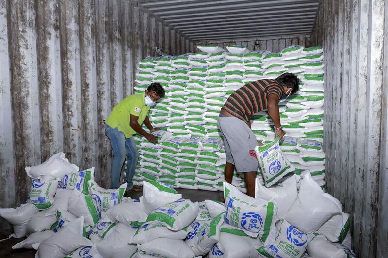 Workers sort out bags of rice seized from a private warehouse in the eastern city of Polonnaruwa, after Sri Lanka declared a state of emergency as most private banks ran out of foreign currency to finance imports of essentials, triggering food shortages. AFP