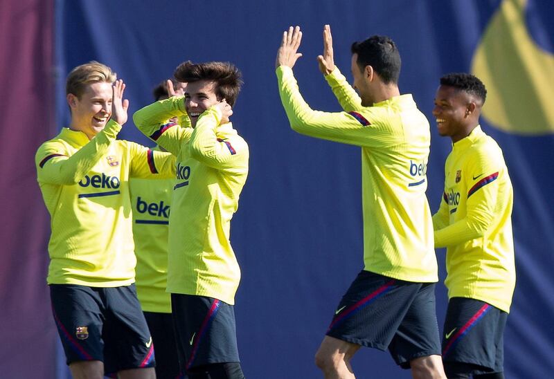 Barcelona's Frenkie de Jong, from left, Riqui Puig, Sergio Busquets and Ansu Fati during training on Friday. EPA