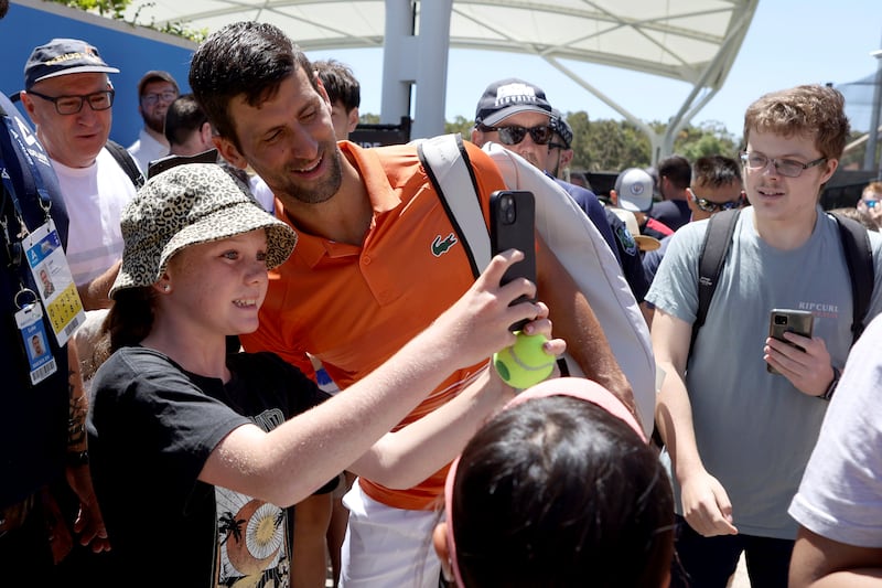 Novak Djokovic poses for a selfie with a young fan. AP Photo 