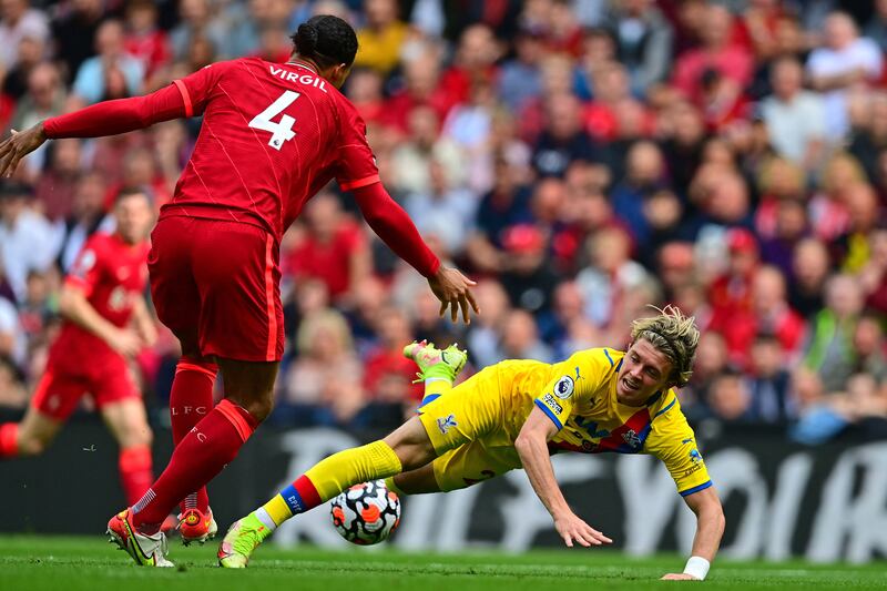 Conor Gallagher tumbles under pressure from Liverpool defender Virgil van Dijk. Reuters