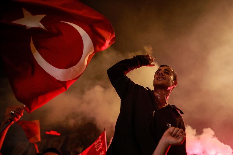 In this photo taken late Sunday, June 24, 2018, a supporter of Turkey's President and ruling Justice and Development Party, or AKP, leader Recep Tayyip Erdogan, chants slogans during celebrations outside the party headquarters in Istanbul. According to unofficial results, Erdogan won 52.6 percent of the votes in the presidential race, avoiding a second-round runoff vote. His ruling Justice and Development Party garnered 42.5 percent of the parliamentary vote. (AP Photo/Emrah Gurel)
