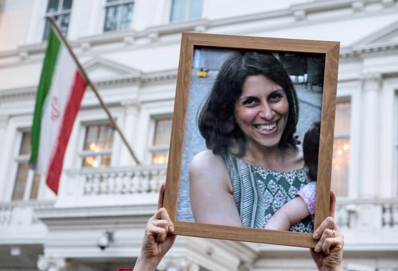 Supporters hold a picture of Nazanin Zaghari-Ratcliffe, who faces a longer jail term in Iran for what her supporters claim are trumped up charges.  Chris J Ratcliffe/Getty Images