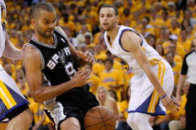 The Golden State Warriors managed to stop Tony Parker's Spurs despite an injury to the Warriors' Stephen Curry, right. Robert Galbraith / Reuters