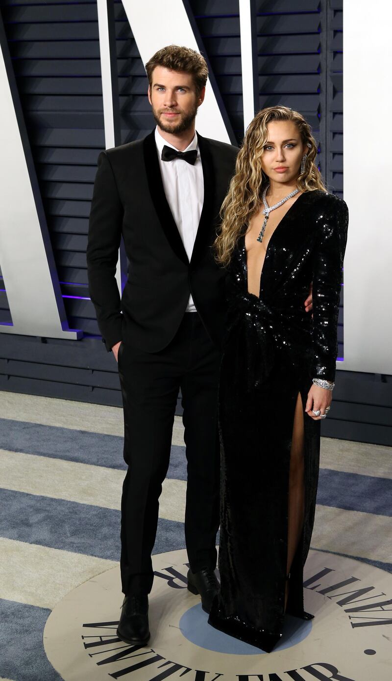 epa07395555 Liam Hemsworth (L) and Miley Cyrus (R) pose at the 2019 Vanity Fair Oscar Party following the 91st annual Academy Awards ceremony, in Beverly Hills, California, USA, 24 February 2019. Black sequined dress by Saint Laurent. The Oscars are presented for outstanding individual or collective efforts in 24 categories in filmmaking.  EPA-EFE/NINA PROMMER