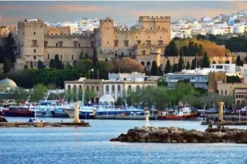 Mandraki Harbour of Rhodes town is dominated by the brooding mass of the Palace of the Grand Masters, a reminder of its medieval glory.