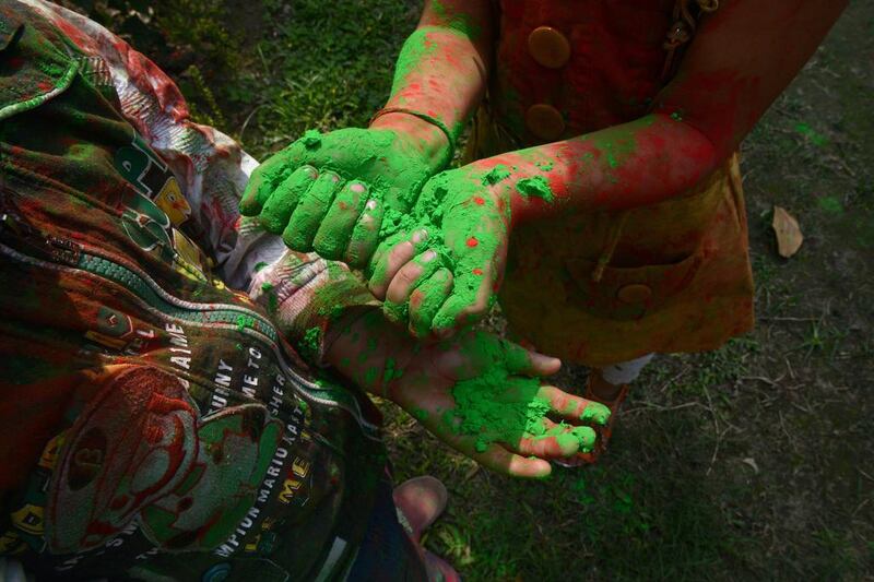 Indian children from the Bright Academy play with coloured powder known as gulal as they celebrate the Holi festival in Siliguri on March 4.   Diptendu Dutta / AFP Photo