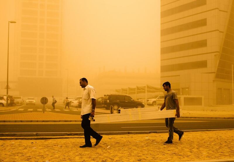 Two men carry work materials through Tecom. Lee Hoagland/The National