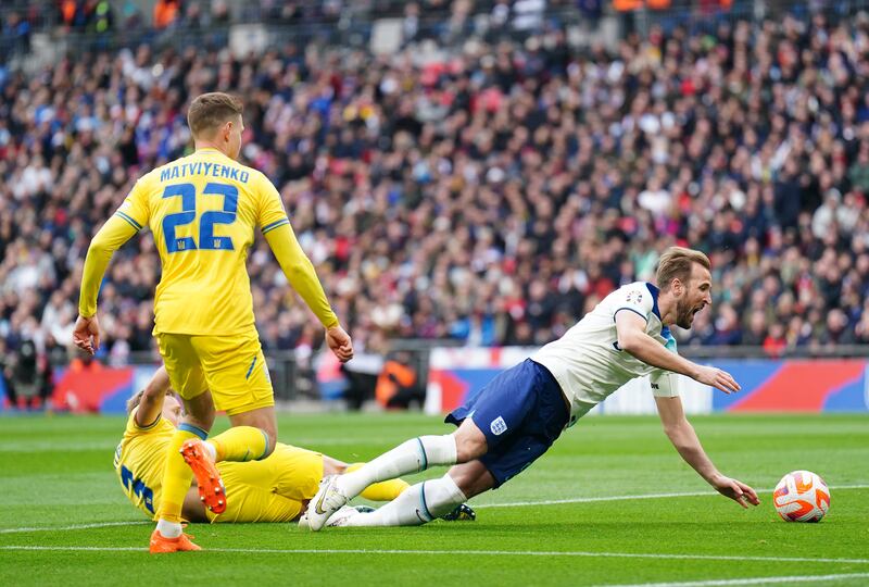 England's Harry Kane goes down in the box after a challenge by Ukraine's Oleksandr Svatok. PA