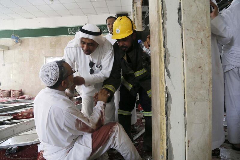 People help a man wounded in the attack. EPA