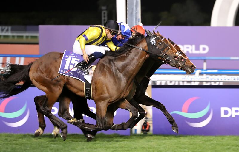 Lord North, in the centre ridden by Frankie Dettori, dead-heated for the Dubai Turf with Yutaka Yoshida on Panthalassa. Pawan Singh / The National