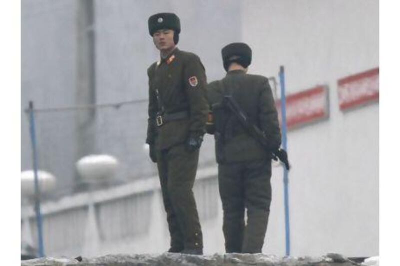 North Korean guards patrol the border with China along the Yalu River. One reader suggests that Pyongyang's provocative acts could be reined in if Beijing took a more active role.