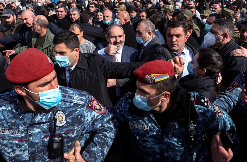 Armenian Prime Minister Nikol Pashinyan, centre, walks with his supporters on the streets of the Yerevan on Thursday, February 2021. Pashinyan called on his followers to support him after he denounced what he called a military coup against him following the army's demand of his resignation.  EPA