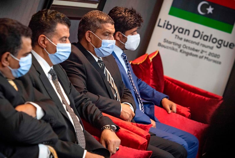 Representatives of Libya's rival administrations take part in a meeting in the coastal Moroccan town of Temara, on October 6, 2020. Libya's rival administrations announced separately in August that they would cease all hostilities and hold nationwide elections, before delegates met in Morocco for talks. / AFP / FADEL SENNA
