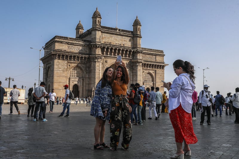 Visitors enjoy leisure time at the Gateway of India, one of Mumbai's main tourist attractions. India’s tourism industry is projected to contribute $512bn to the country's GDP by 2028, according to a government investment agency. EPA