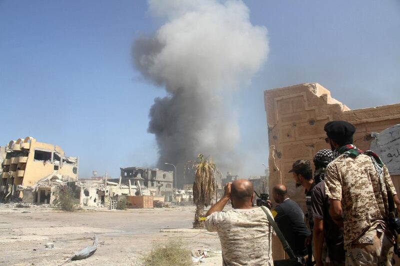 Libyan forces allied with the UN-backed government take cover during a battle with ISIL in Sirte on October 2, 2016. Hani Amara / Reuters