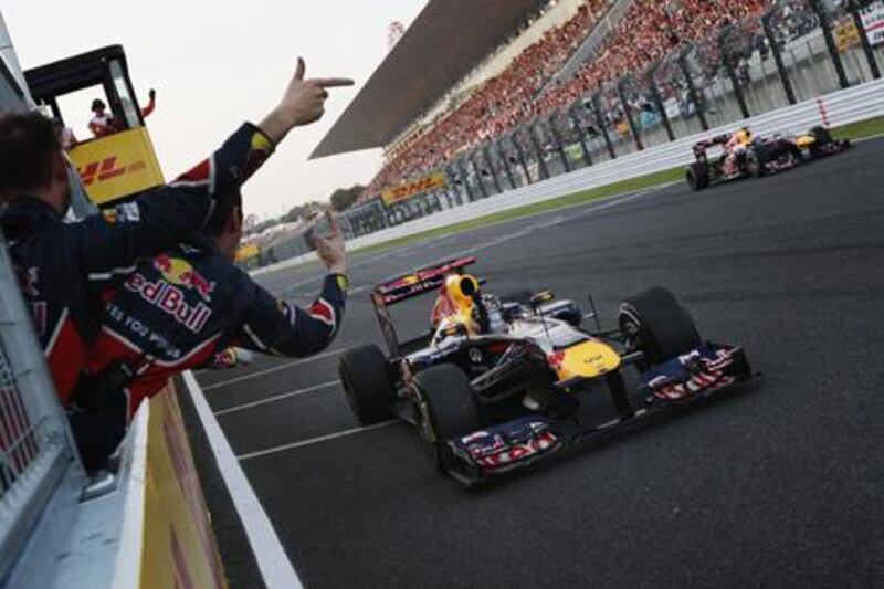 SUZUKA, JAPAN - OCTOBER 09:  Sebastian Vettel of Germany and Red Bull Racing celebrates in front of team mates after finishing third to secure his second F1 World Drivers Championship during the Japanese Formula One Grand Prix at Suzuka Circuit on October 9, 2011 in Suzuka, Japan.  (Photo by Ker Robertson/Getty Images)