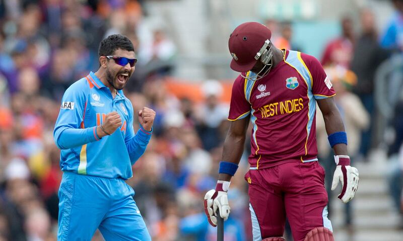 India's Ravindra Jadeja, left, celebrates taking his fifth wicket of the game, that of West Indies' Ravi Rampaul, not pictured, beside West Indies' Darren Sammy, right, during the ICC Champions Trophy group B cricket match between India and West Indies at The Oval cricket ground in London, Tuesday, June 11, 2013.  (AP Photo/Matt Dunham) *** Local Caption ***  Britain ICC Trophy India West Indies.JPEG-00378.jpg
