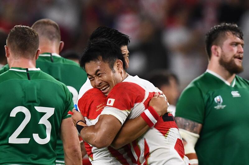 Japan's players celebrate after winning the Japan 2019 Rugby World Cup Pool A match between Japan and Ireland at the Shizuoka Stadium Ecopa in Shizuoka on September 28, 2019. / AFP / Anne-Christine POUJOULAT
