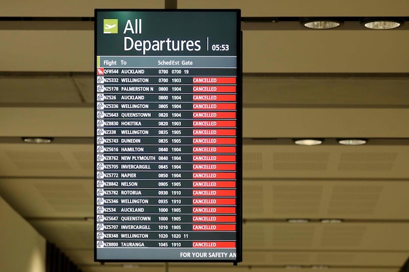 A signboard shows cancelled flights at the departures area at Christchurch Airport in Christchurch on April 8, 2020. New Zealand is on lockdown for a four-week period that started on March 25 to avoid the spread of the COVID-19 coronavirus. / AFP / Sanka VIDANAGAMA
