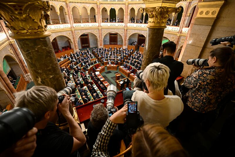Photographers take pictures as Hungarian Prime Minister Viktor Orban stands after addressing a parliament session, on the day politicians were expected to approve Sweden's accession into Nato, in Budapest. AP