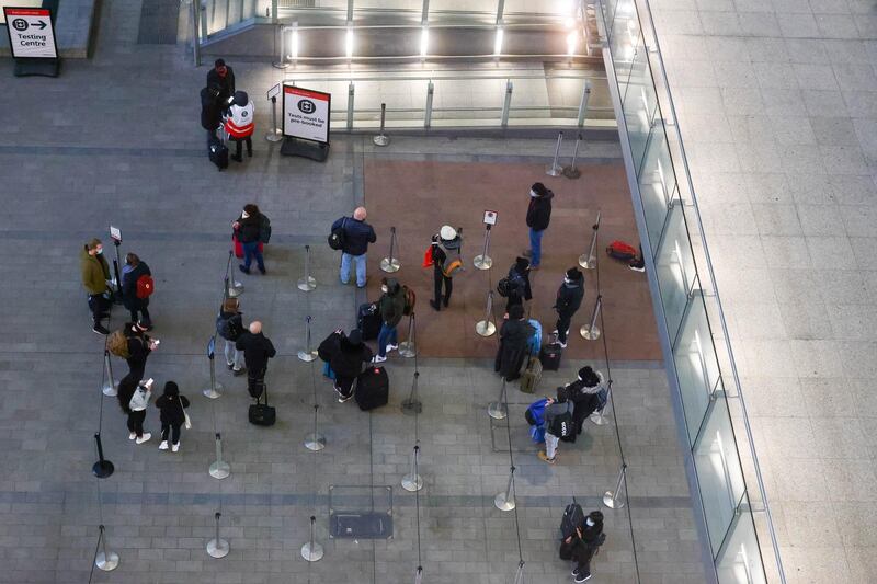 Travelers stand in line for Covid-19 tests after arriving at Heathrow Airport. UK ministers have closed travel corridors with other countries from Monday. Bloomberg