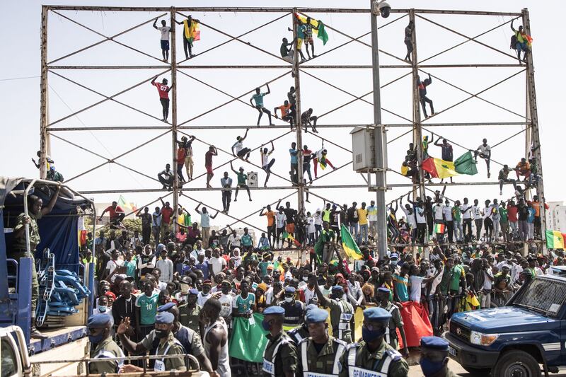 Supporters cheers ahead of the Senegalese football team's arrival in Dakar on Monday, January 7, 2022, after winning the Africa Cup of Nations. AFP