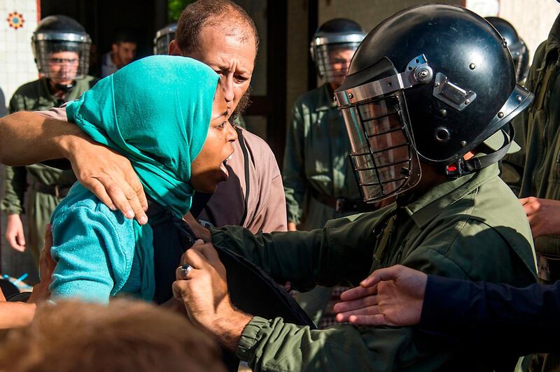Unemployed and visually impaired Moroccan graduates scuffle with security forces as they try to enter the ministry of Solidarity, Women, Family and Social Development in Rabat.  AFP