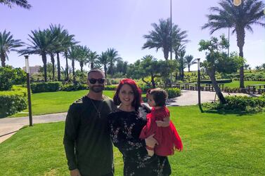 Abu Dhabi residents Emily and Nader Musharbash with their daughter Tia. The couple have saved Dh6,000 a month by cutting their expenditure. Courtesy Emily Musharbash