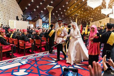 Prince Abdul Mateen and Yang Mulia Anisha Rosnah walk down the aisle during their wedding reception at Istana Nurul Iman in Brunei's capital Bandar Seri Begawan on January 14. AFP
