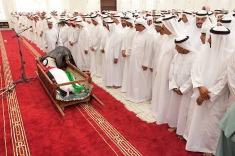 UAE - RAK- Oct 27 - 2010: An Imam kiss the body of Sheikh Saqr bin Mohammed al Qasimi, the Ruler of Ras al Khaimah, during his funeral prayer at Sheikh Zayed Mosque. ( Jaime Puebla - The National Newspaper )