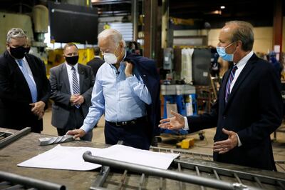 Democratic presidential candidate, former Vice President Joe Biden, center, listens to McGregor Industries owner Bob McGregor, right, give a tour of the metal fabricating facility, Thursday, July 9, 2020, in Dunmore, Pa. (AP Photo/Matt Slocum)