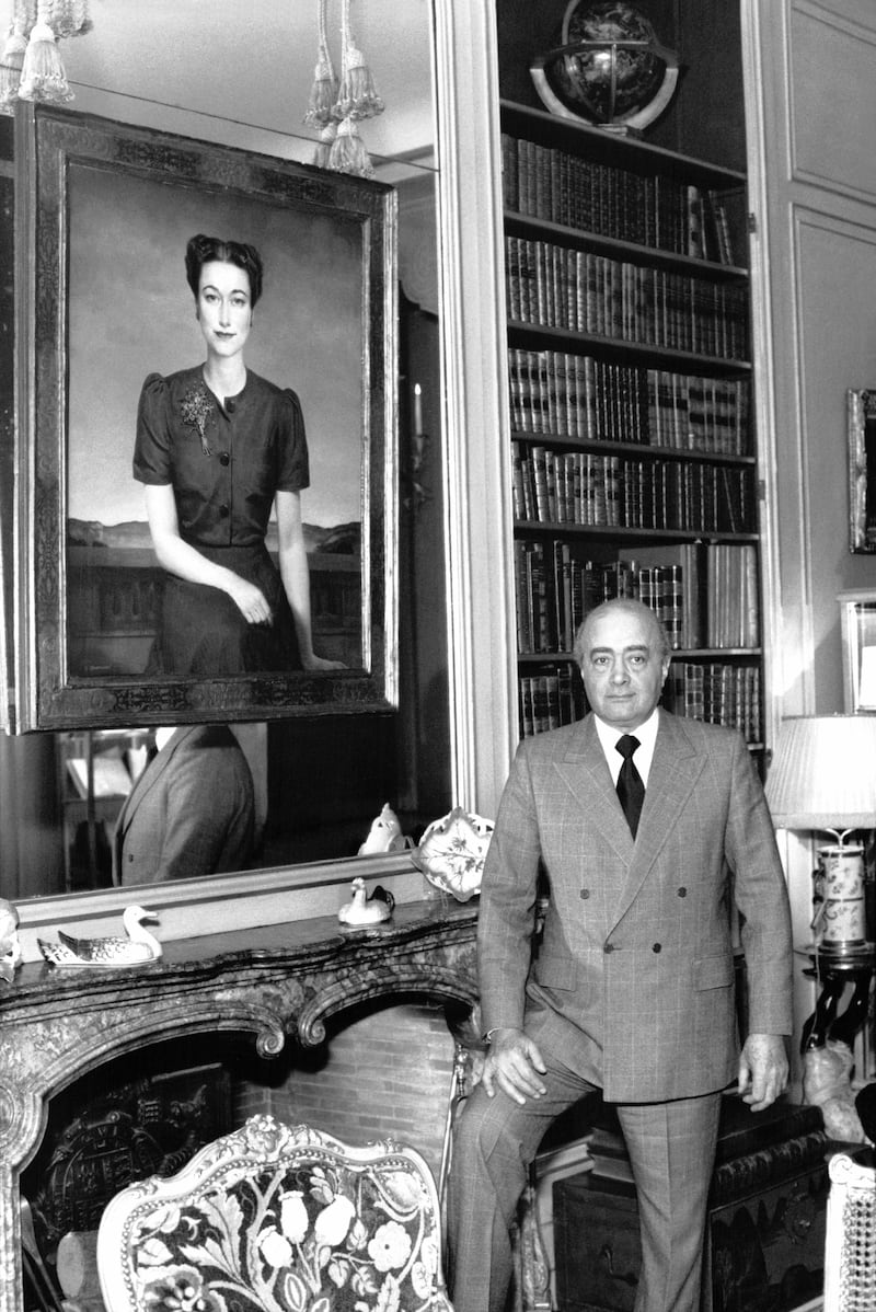 Mr Al-Fayed poses with a portrait of the Duchess of Windsor, in Boulogne-Billancourt, France. Getty Images