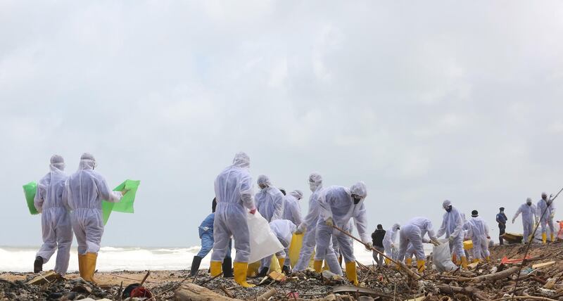 Clean-up teams clear debris from the fire-ravaged 'MV X-Press Pearl'. EPA