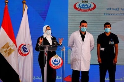 (L to R) Egyptian Health Minister Hala Zayed gives a press conference, accompanied by doctor Abdelmouim Selem and medical staff member Ahmed Hemdan, in a tent set up outside the Abou Khalifa hospital, in Ismailia, about 120kms east the capital Cairo, on January 24, 2021, after the two men received a doze of a coronavirus vaccine.     Egypt began its nationwide Covid-19 immunisation program today, with a doctor and a nurse receiving the Chinese-made Sinopharm jab. / AFP / Khaled DESOUKI
