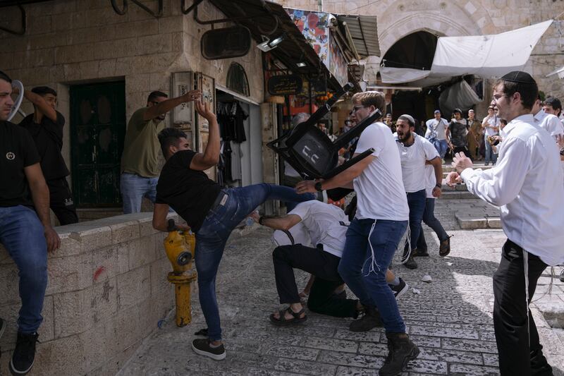 Palestinians and Jewish youths clash in Jerusalem's Old City as Israelis mark Jerusalem Day, an Israeli holiday celebrating the capture of the Old City in 1967. AP