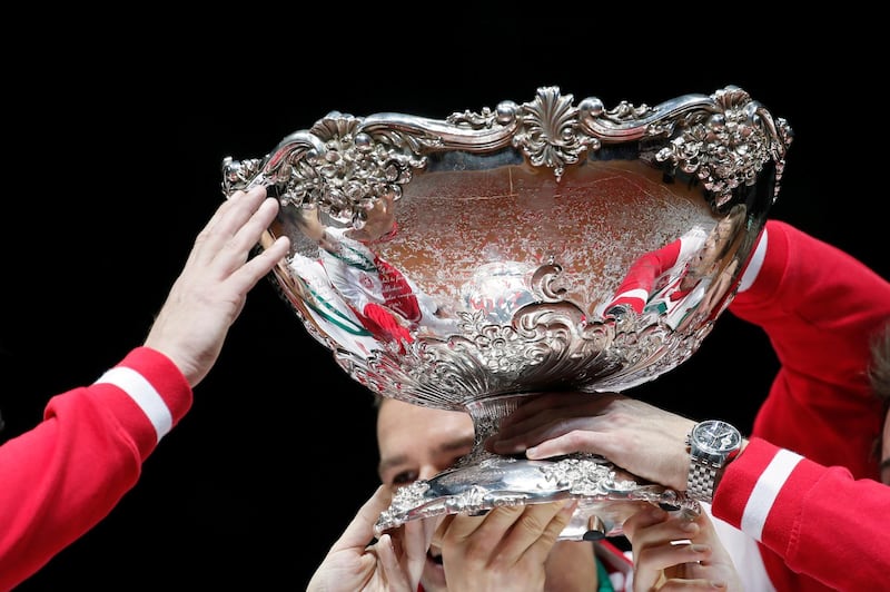 FILE PHOTO: Switzerland's team members hold the trophy after winning the Davis Cup final against France at the Pierre-Mauroy stadium in Villeneuve d'Ascq, near Lille, November 23, 2014.  REUTERS/Gonzalo Fuentes/File Photo