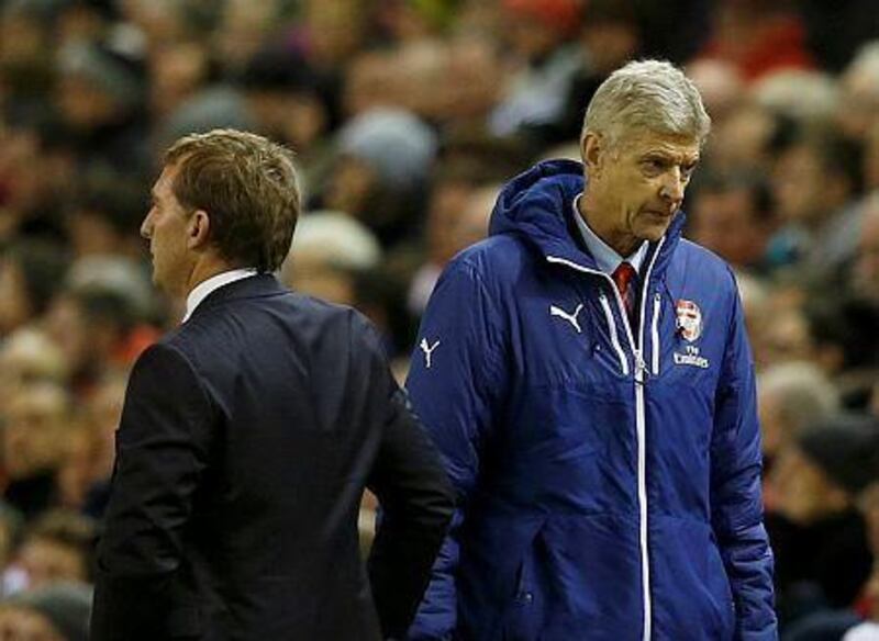 Arsenal manager Arsene Wenger, right, and Liverpool manager Brendan Rodgers stand next to each other during their English Premier League match at Anfield in Liverpool, northern England on December 21, 2014. REUTERS/Phil Noble