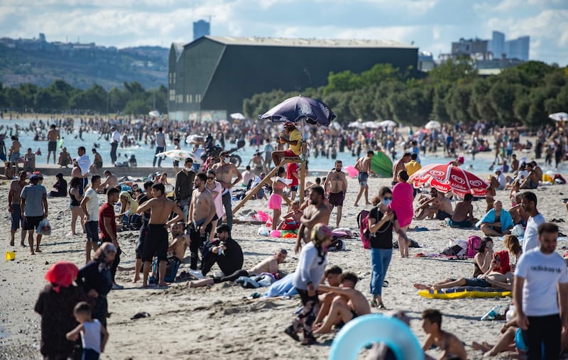 People soak in the sun at the Menekse beach amid the ongoing pandemic of coronavirus on sunset in Istanbul, Turkey. AFP