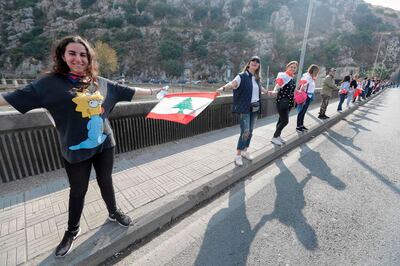 Lebanese protesters form a human chain along the coast from north to south as a symbol of unity during ongoing anti-government demonstrations in Nahr al-Kalb north of Lebanon's capital Beirut on October 27, 2019. / AFP / JOSEPH EID
