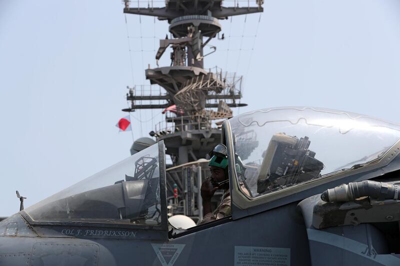 A US Marine maintains an AV-8B Harrier aircraft.