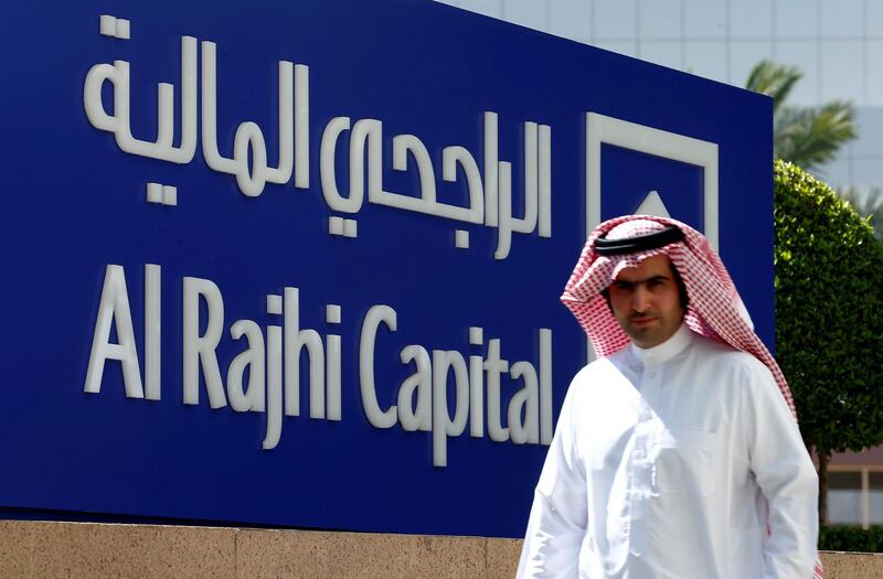 FILE PHOTO: A man walks past a sign of Al Rajhi Capital company in Riyadh, Saudi Arabia, November 8, 2017. REUTERS/Faisal Al Nasser/File Photo