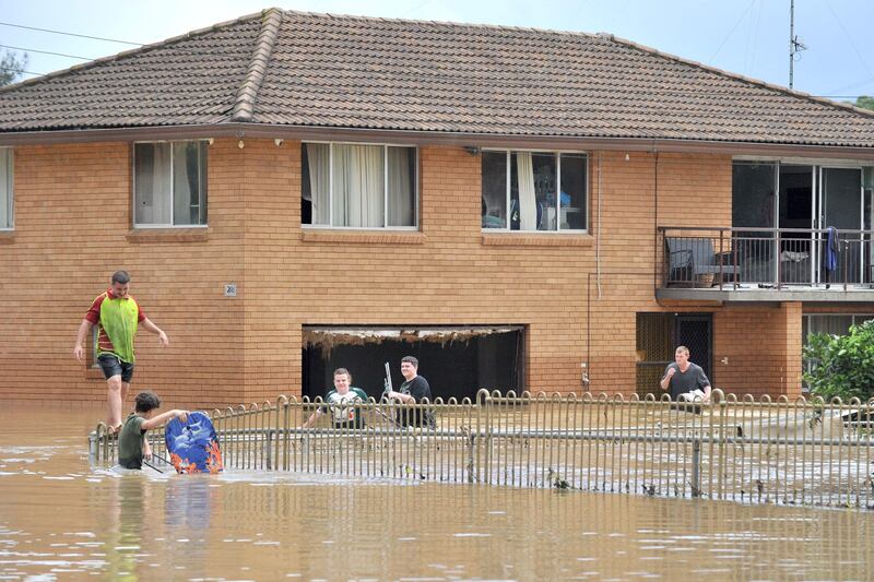 Residents remove their belongings from their flooded home in western Sydney. AFP