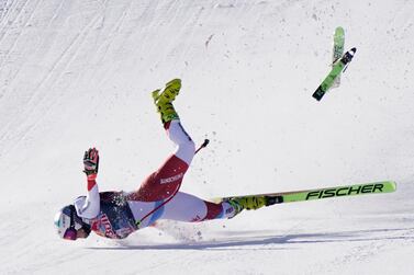 Switzerland's Urs Kryenbuehl crashes at finish line during an alpine ski, men's World Cup downhill in Kitzbuehel, Austria, Friday, Jan. 22, 2021. (AP Photo/Giovanni Auletta)